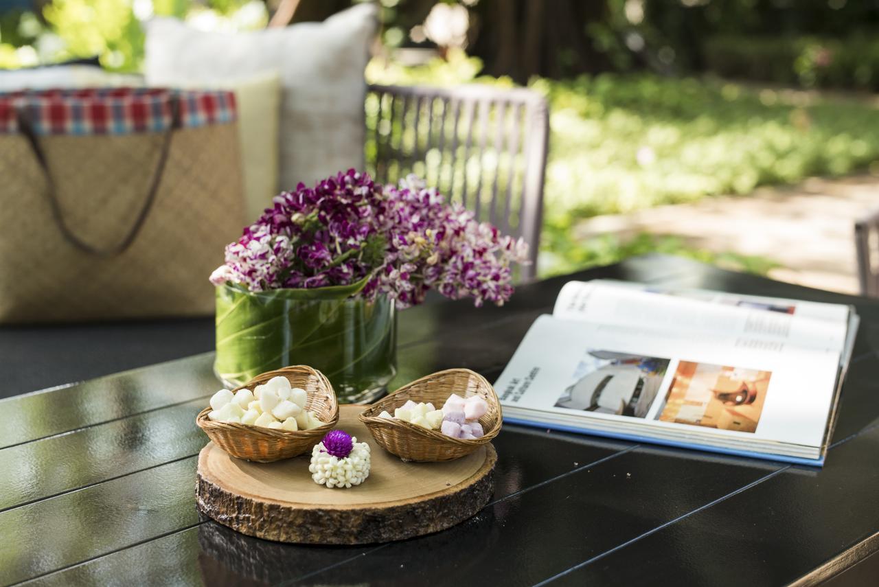 The Raweekanlaya Bangkok Kültér fotó A picnic table with a book and flowers